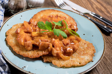 Homemade potato pancakes with goulash.