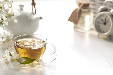 Spa resort at home with tea made of jasmine flowers on a white background. Copy space. Spa and wellness concept.