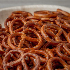Pretzels on a plate on the kitchen table. Snack on beer. Salty snack. Crispy pretzels. Beer snacks