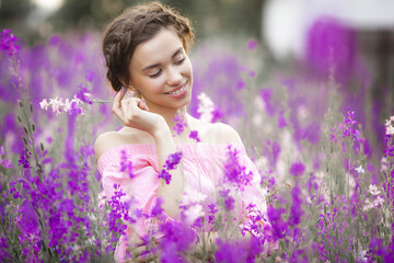 Very beautiful young woman with flowers. Close up portrait of attractive female