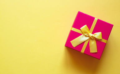 gift box with bow on yellow background