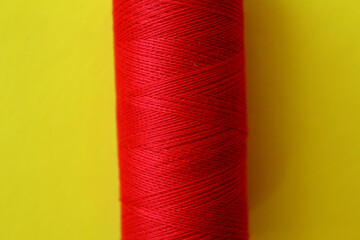 Colored thread for embroidery.Sewing thread. Threads for sewing on yellow background