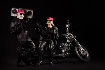 Fototapeta na wymiar Photo of old bikers grey hair man lady couple moto chopper rock festival meeting listen tape recorder heavy metal music show horns wear rocker leather outfit isolated black color background