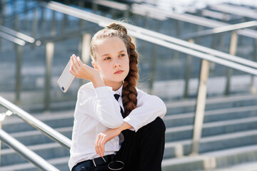 Little school girl having phone talk with friend. modern life communication. Living in digital age.