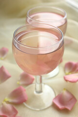 Two glasses with pink lemonade and rose petals. Romantic date, event.