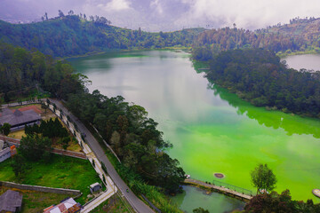 Aerial view of a Colour Lake (Telaga Warna) Dieng (Wonosobo) on a sunny day.