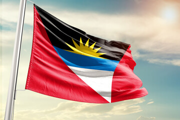 Antigua and Barbuda national flag cloth fabric waving on the sky with beautiful sun light - Image