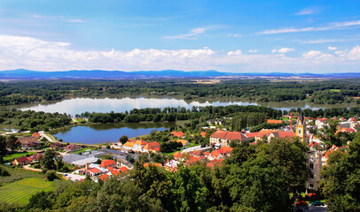 Fototapeta na wymiar Picturesque aerial view at the famous Czech town Hluboka nad Vltavou from the castle on the blue sky background.