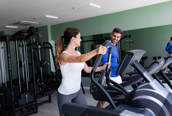 Fototapeta na wymiar Smiling couple exercising at home gym.