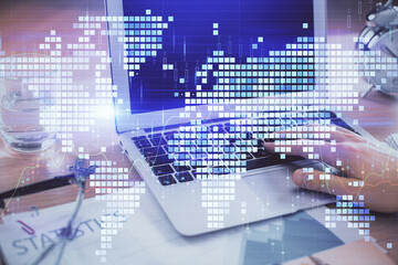 Multi exposure of businessman working on laptop on background. International business hologram in front. Concept of success.