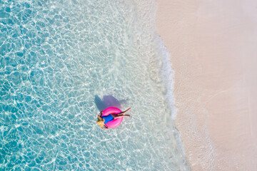 Top above high angle aerial drone view of her she attractive girl floating on rubber ring in clean...