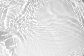 Closeup of desaturated transparent clear calm water surface texture with splashes and bubbles. Trendy abstract nature background