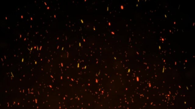 Burning red hot sparks flying from large fire flame on black background.