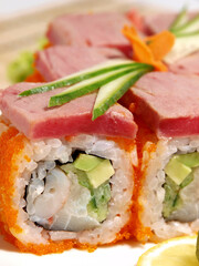 Japanese roll with tuna, shrimp, avocado and caviar close-up