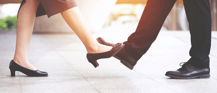 People greeting foot tap. New normal greeting to avoid the spread of coronavirus. businessman and woman meet, instead with a hug or alternative handshake, touch their feet together. social distancing