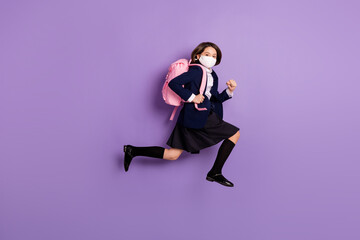 Fototapeta na wymiar Full length body size profile side view of her she active small little energetic long-haired girl jumping running late to lesson grade wearing mask isolated lilac violet pastel color background