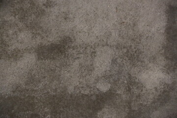 fondo abstracto con manchas grises sobre suelo de cemento