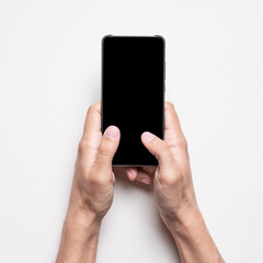 Two hands of man holding modern black mobile phone. Mockup blank screen smartphone