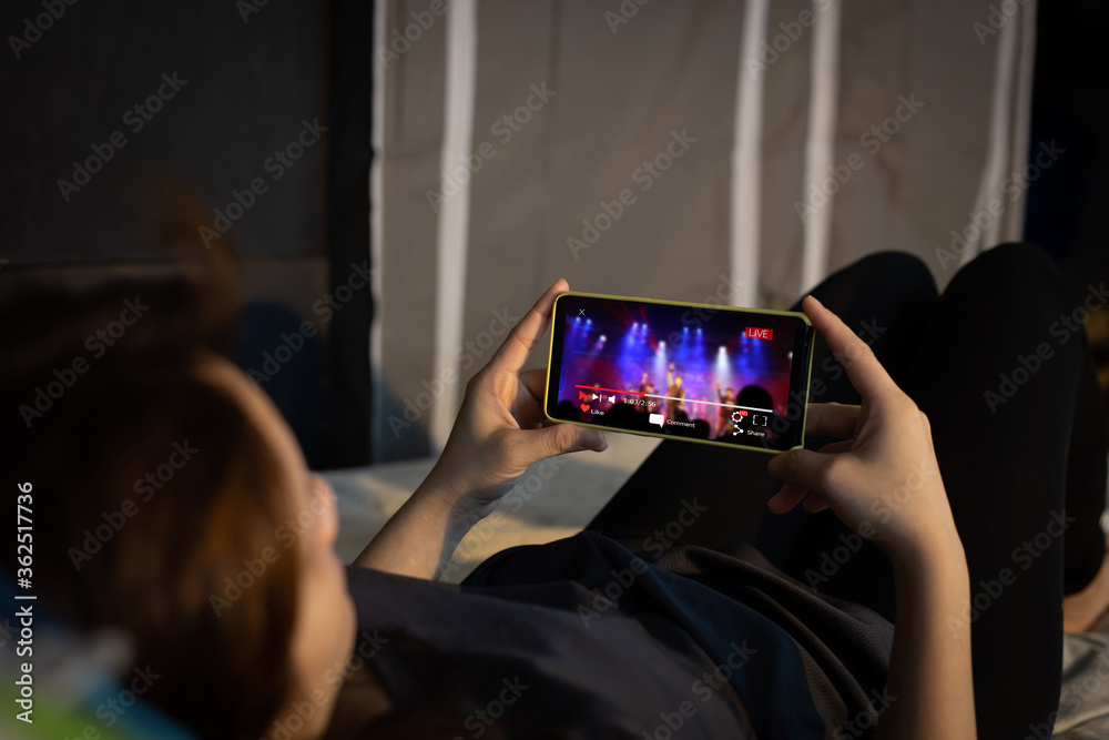 Wall mural live video streaming concept.female hands holding mobile phone