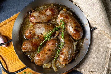 Homemade white sausage fried with onion and herbs