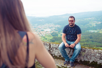 Two friends having a conversation in front of a beautiful landscape