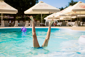 legs stick out of the pool
