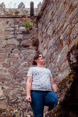 Pregnant woman climbing the stairs of a medieval castle