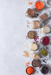 Legumes, seeds and cereals on a gray background. Healthy food. Top view, copy of space.