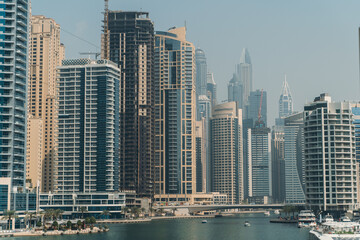Obraz na płótnie Canvas Dubai Marina skyscrapers with boats in water canal, Dubai, United Arab Emirates.