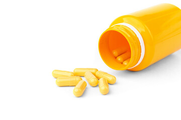 Yellow capsules or pills isolated on white background.