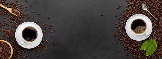 cup of coffee and bean on black wooden table background. top view