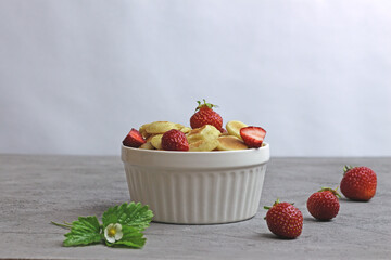 Small grain pancakes with strawberries, fast healthy Breakfast, pancake porridge on a gray background.