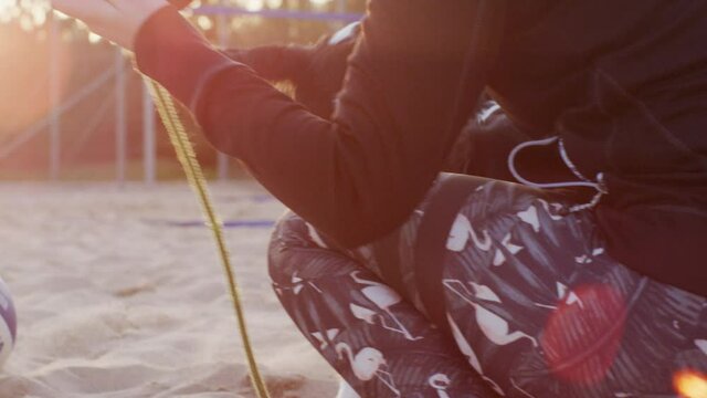 Cute young rare Stabyhoun Stabij pure breed puppy dog kid playing tug-of-war with his mom who tries to catch him whilst he jumps around in happiness and joy with the rope in mouth teeth