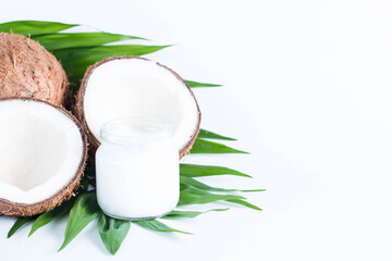 Ripe half cut coconut on a wooden background. Coconut cream and oil.