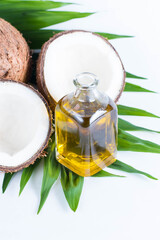 Ripe half cut coconut on a wooden background. Coconut cream and oil.