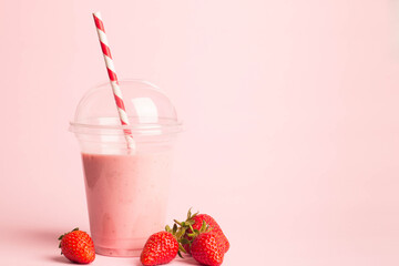 Glass of fresh strawberry milkshake, smoothie and fresh strawberries on pink, white and wooden background. Healthy food and drink concept.