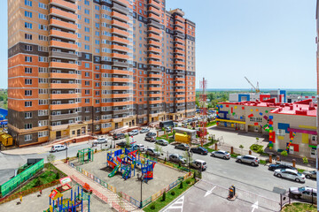 The courtyard of a modern residential multistory building with the children's playground and the building of a kindergarten. Rostov-on-Don / Russia - 07 may 2019