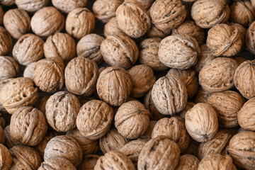 Lots of walnuts top view, texture and background of walnuts, selective focus