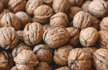 Lots of walnuts top view, texture and background of walnuts, selective focus