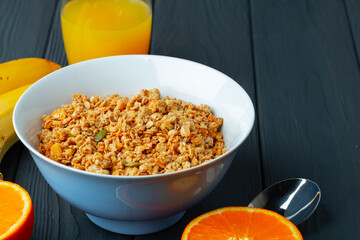 Bowl with granola on wooden table close up