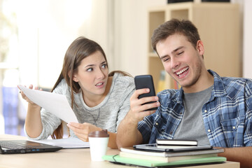 Fototapeta premium Angry student complaining to slacker classmate at home