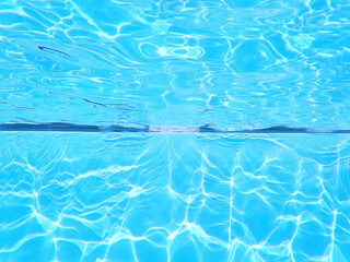 Swimming pool underwater background. Chlorine water treatment and  sanitation. Empty copy space with no people for Editor's text.