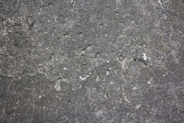 Muddy concrete wall with cracks and black spots. Old and dirty tested wall background. Architecture and construction works. Close-up old weathered concrete texture of the wall.
