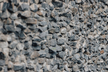 Stone wall. Detailed texture of a wall lined with cobblestones with cement.