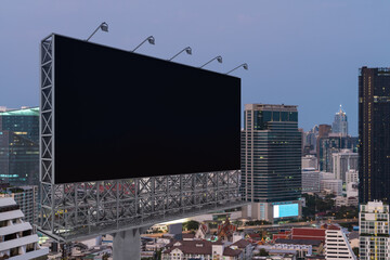 Blank black road billboard with Bangkok cityscape background at sunset. Street advertising poster, mock up, 3D rendering. Side view. The concept of marketing communication to promote or sell idea.