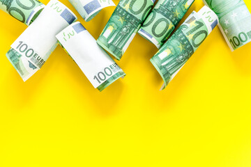 A lot of euro banknote on yellow background top view