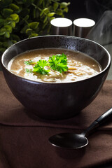 Hot mushroom soup with noodles. Small depth of field.