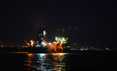 Fototapeta na wymiar service ship captured at night with beautiful lights all around.