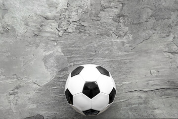 Soccer ball on grey background top view copy space