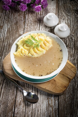 Pure white borscht served with mashed potatoes.